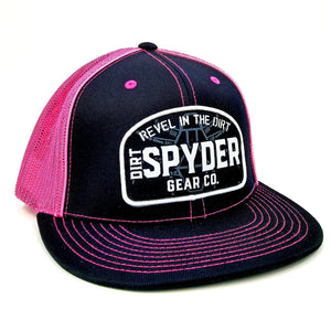 REVEL IN THE DIRT WOVEN PATCH PINK/BLACK TRUCKER HAT